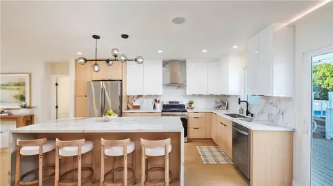 Modern kitchen with two-tone cabinets and waterfall island, 5864 Jamieson Ave, Encino