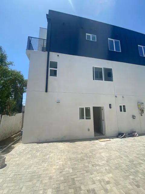 Three-story duplex exterior with paver courtyard, North Hollywood