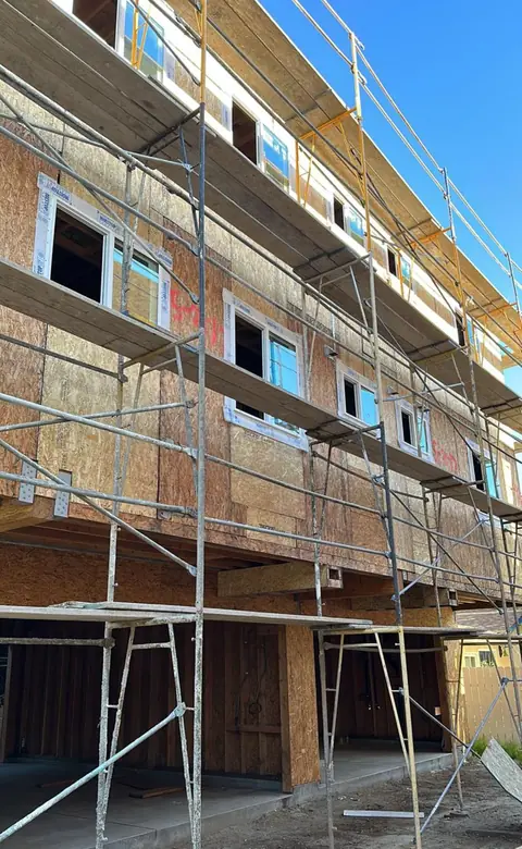Three-story duplexes under construction with scaffolding, North Hollywood